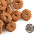 Load image into Gallery viewer, Brown dog treats with a quarter for scale on a white background